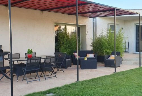 Bâche étanche rouge pour pergola métallique, aménagement moderne d'une terrasse extérieure